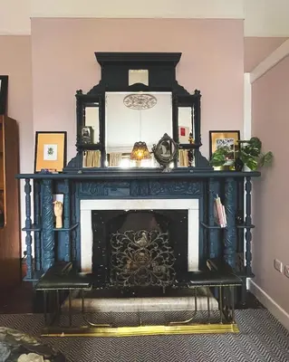 a fireplace in a living room with a black mantle at Bala Suite at pen Y Coed Hall in Dolgellau