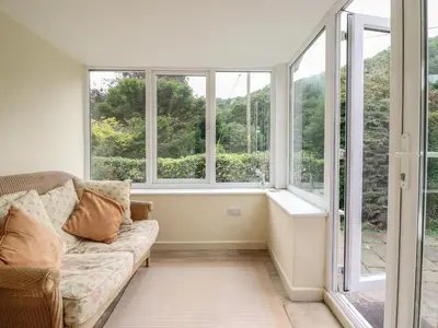 a living room with windows and a couch at Hafod in Llangollen