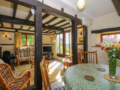 a dining room with a table and chairs at Callow Cottage in Craven Arms