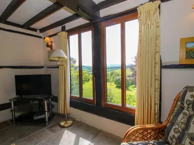 a living room with a large window with a view at Callow Cottage in Craven Arms