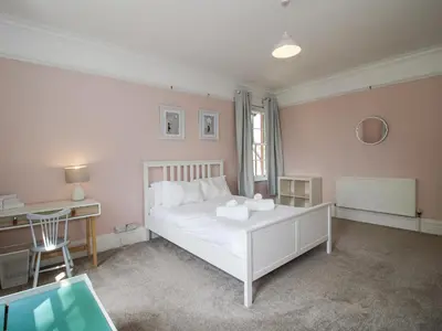 a bedroom with a white bed and a desk at The Old Vicarage in Leominster