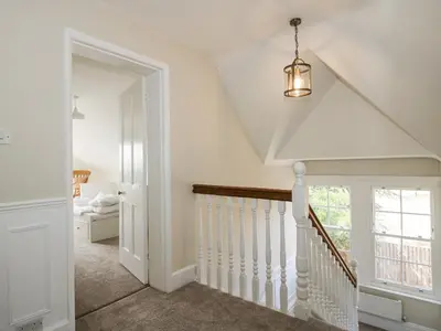 a white staircase in a home with a window at The Old Vicarage in Leominster