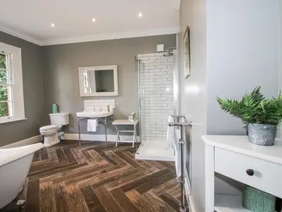 a bathroom with a toilet and a sink and a shower at The Old Vicarage in Leominster