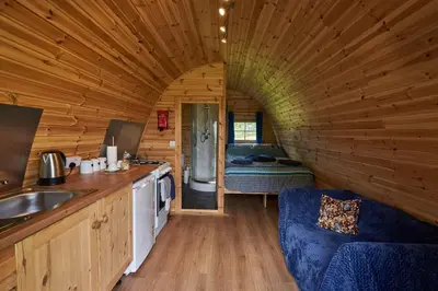 a kitchen and living room in a log cabin at Pencastell Views in Nantcwnlle