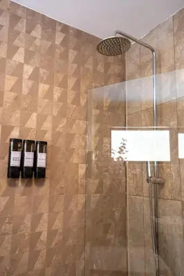 a bathroom with a shower with a glass door at Modern Bungalow Views of Pen y Fan in Brecon