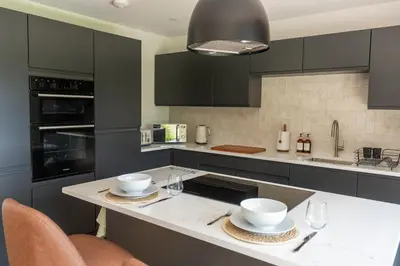 a kitchen with a counter with two bowls on it at Modern Bungalow Views of Pen y Fan in Brecon