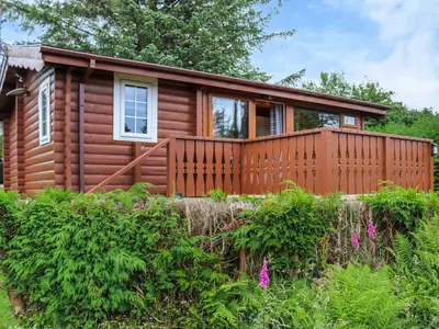 a log cabin with a wooden fence at Barken in Trawsfynydd