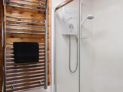 a shower in a bathroom with a glass door at Barken in Trawsfynydd