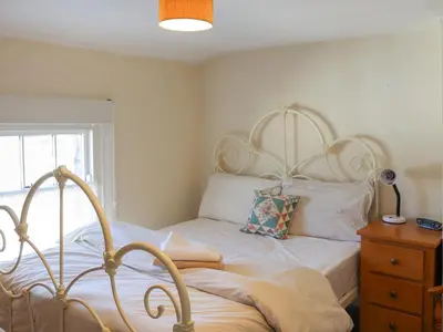 a bedroom with a bed and a window at Crescent Cottage in Newtown