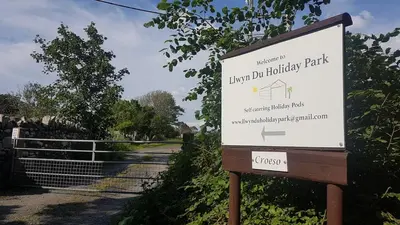 a sign for the lincoln dip holiday park at CABIN 8 Pet friendly Family glamping Seaview in Llwyngwril