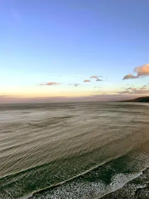 a view of the ocean from a beach at sunset at CABIN 8 Pet friendly Family glamping Seaview in Llwyngwril