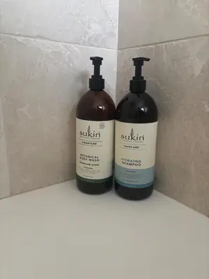 two bottles of soap sitting on a counter at Honey Bee Cottage Tiny House Welshpool in Welshpool