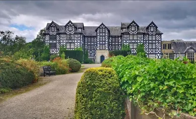 a large black and white building with a pathway at Honey Bee Cottage Tiny House Welshpool in Welshpool