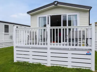 a white fence in front of a house at The Laughing Seagull - Uk50213 in Aberystwyth