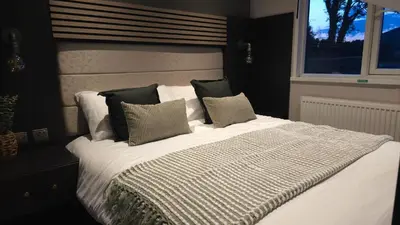 a bedroom with a bed with pillows and a window at Daverneithon 3 in Rhayader