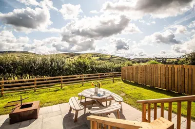 a patio with a table and chairs and a fence at Daverneithon 3 in Rhayader