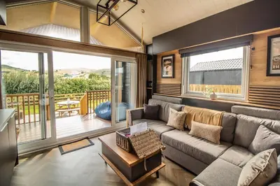 a living room with a couch and a balcony at Daverneithon 2 in Rhayader