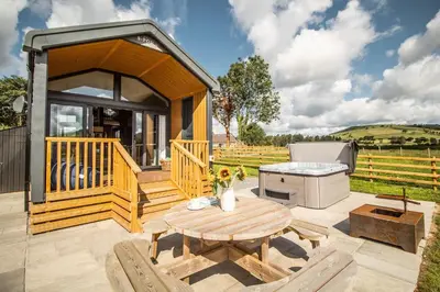 a gazebo with a picnic table and a grill at Daverneithon 4 in Rhayader