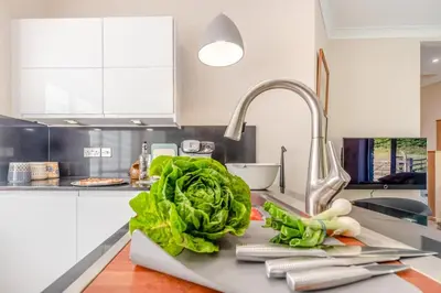 a kitchen counter with lettuce and vegetables on a sink at 2 Bed in Llanybydder oc-b32255 in Cwrt-newydd