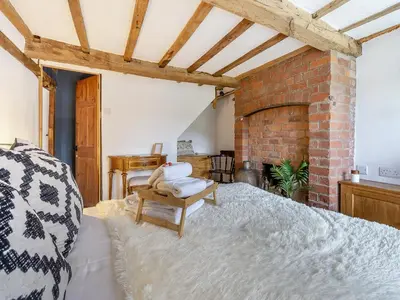 a room with a bed and a brick wall at Pen Y Groes in Welshpool