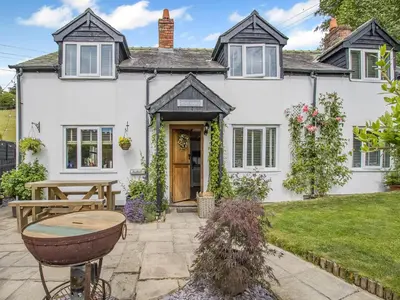 a white house with a table in front of it at Pen Y Groes in Welshpool