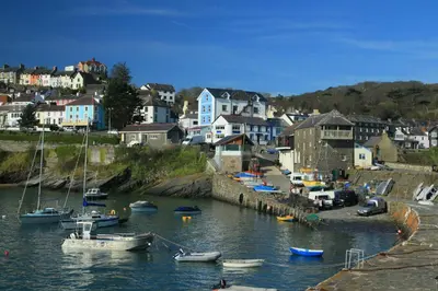a group of boats are docked in a harbor at Sailhouse Loft New Quay in New Quay