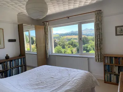 a bedroom with a bed and a large window at Brecon with Spectacular Views in Brecon