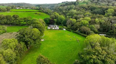 an aerial view of a house in a green field at Five Oaks B&B - New Quay in Llanina