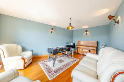 a living room with white furniture and a piano at 4 Bed in Talybont oc-y32384 in Talybont