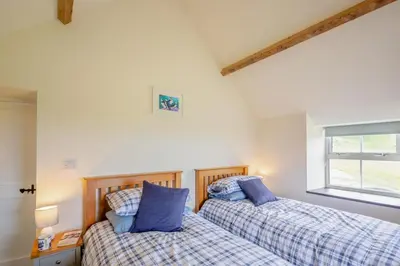 two beds sitting next to each other in a bedroom at 3 Bed in Tywyn oc-b32570 in Llangelynin