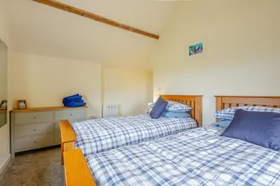 a bedroom with two beds and a dresser at 3 Bed in Tywyn oc-b32570 in Llangelynin