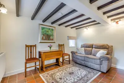 a living room with a couch and a table at 2 Bed in Yatton oc-s32603