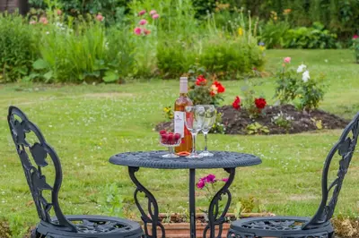a table with a bottle of wine and a glass at 2 Bed in Yatton oc-s32603