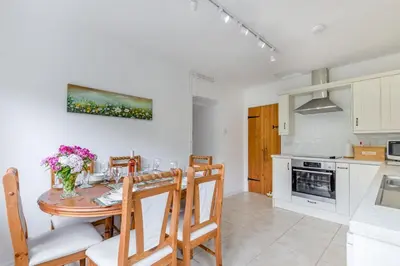 a kitchen and dining room with a table and chairs at 2 Bed in Yatton oc-s32603