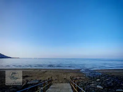 a beach with the ocean in the background at The Ocean Nook in New Quay