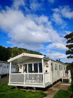 a white mobile home with a white porch at The Ocean Nook in New Quay