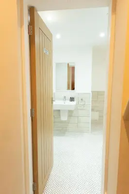 a bathroom with a sink and a mirror at The Barmouth Bar & Grill in Barmouth