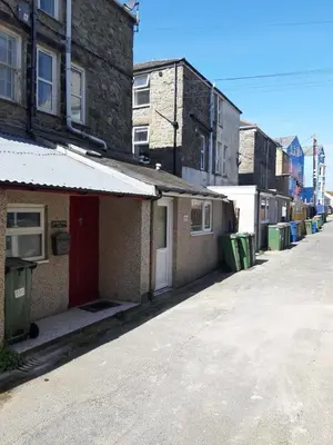 an empty street in a city with buildings at Barmouth Beach Ground Floor Studio in Barmouth