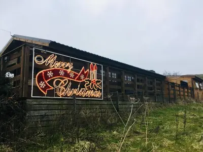 a building with graffiti on the side of it at Perfect getaway Cabin Haf with Hot Tub in Llanrhaeadr-ym-Mochnant