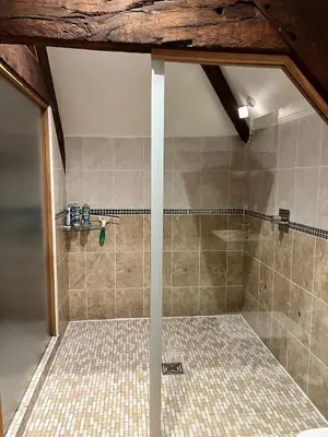 a shower with a glass door in a bathroom at Rooftops Loft in Hay-on-Wye