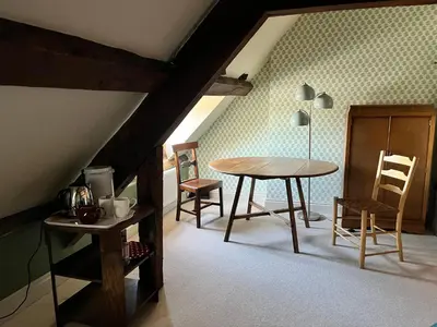 a room with a table and chairs in a attic at Rooftops Loft in Hay-on-Wye