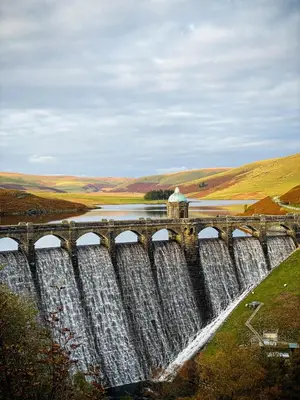 a bridge over a dam with waterfalls at Vern Dale Cottage, Erwood, River Wye, Builth Wells in Builth Wells