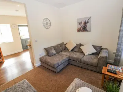 a living room with a couch and a table at Vern Dale Cottage, Erwood, River Wye, Builth Wells in Builth Wells
