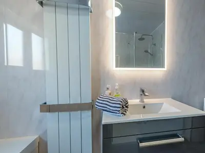 a bathroom with a sink and a mirror at Spring Gardens in New Quay