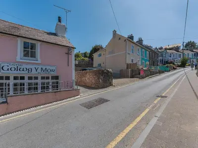 an empty street in a small town with houses at Spring Gardens in New Quay