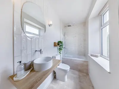 a bathroom with a tub and a sink and a toilet at Lansdowne House in Brecon