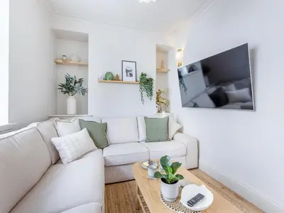 a white living room with a white couch and a table at Lansdowne House in Brecon