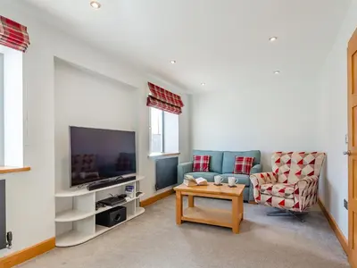 a living room with a couch and a table at Hafod Y Morfa - Uk48829 in Harlech