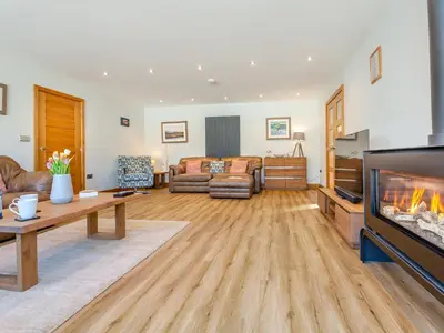 a living room with a fireplace and a couch at Hafod Y Morfa - Uk48829 in Harlech
