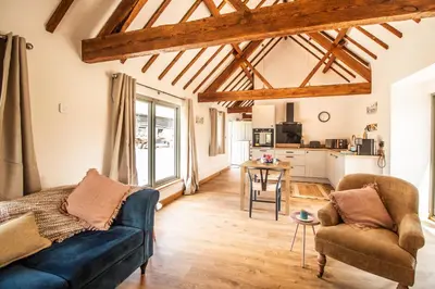 a living room with a couch and a table at Wyns Barn in Rhayader